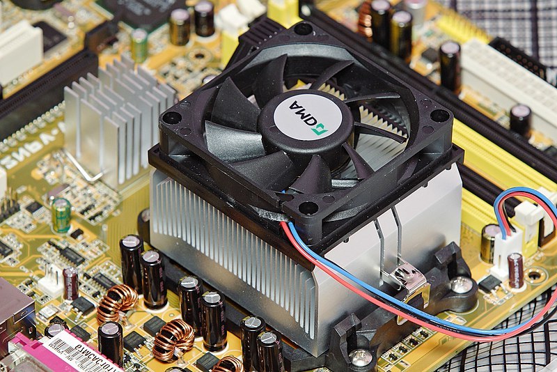 Un disipador de calor enfriado por ventilador en el procesador de una computadora personal. A la derecha hay un disipador de calor más pequeño que enfría otro circuito integrado de la placa madre.